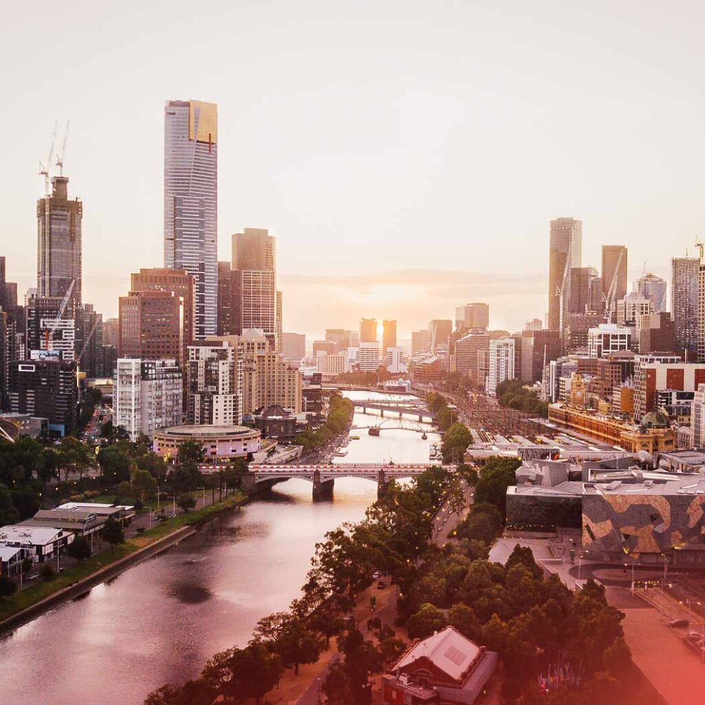 An aerial view of Melbourne's city skyline and Yarra River at sunset, reflecting a dynamic hub for business finance.