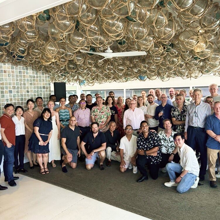 Diverse Octet team members pose together at a company event, highlighting a strong workplace community.